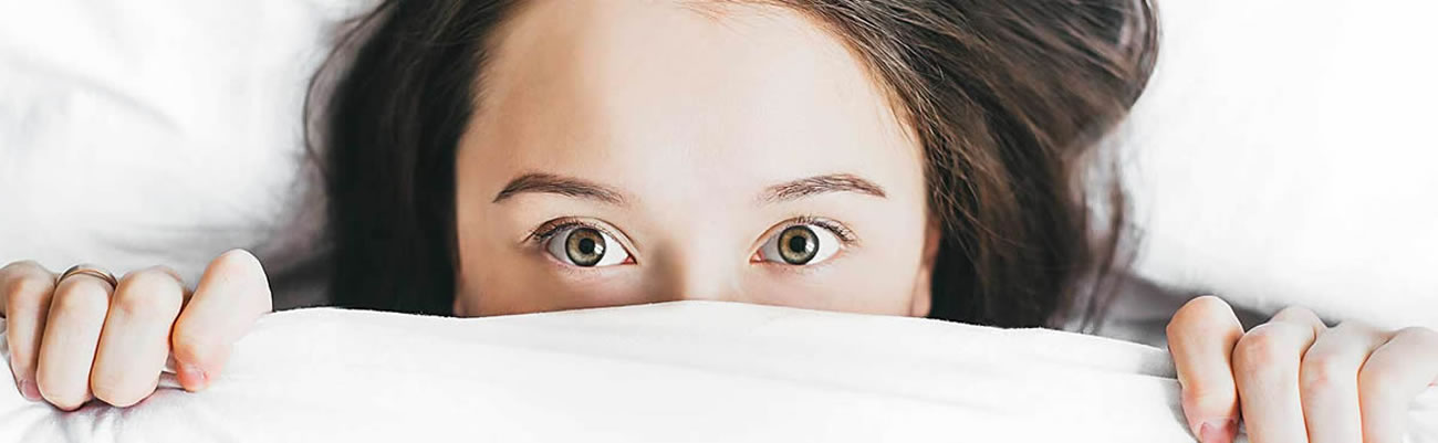 Image of an unwell person in bed